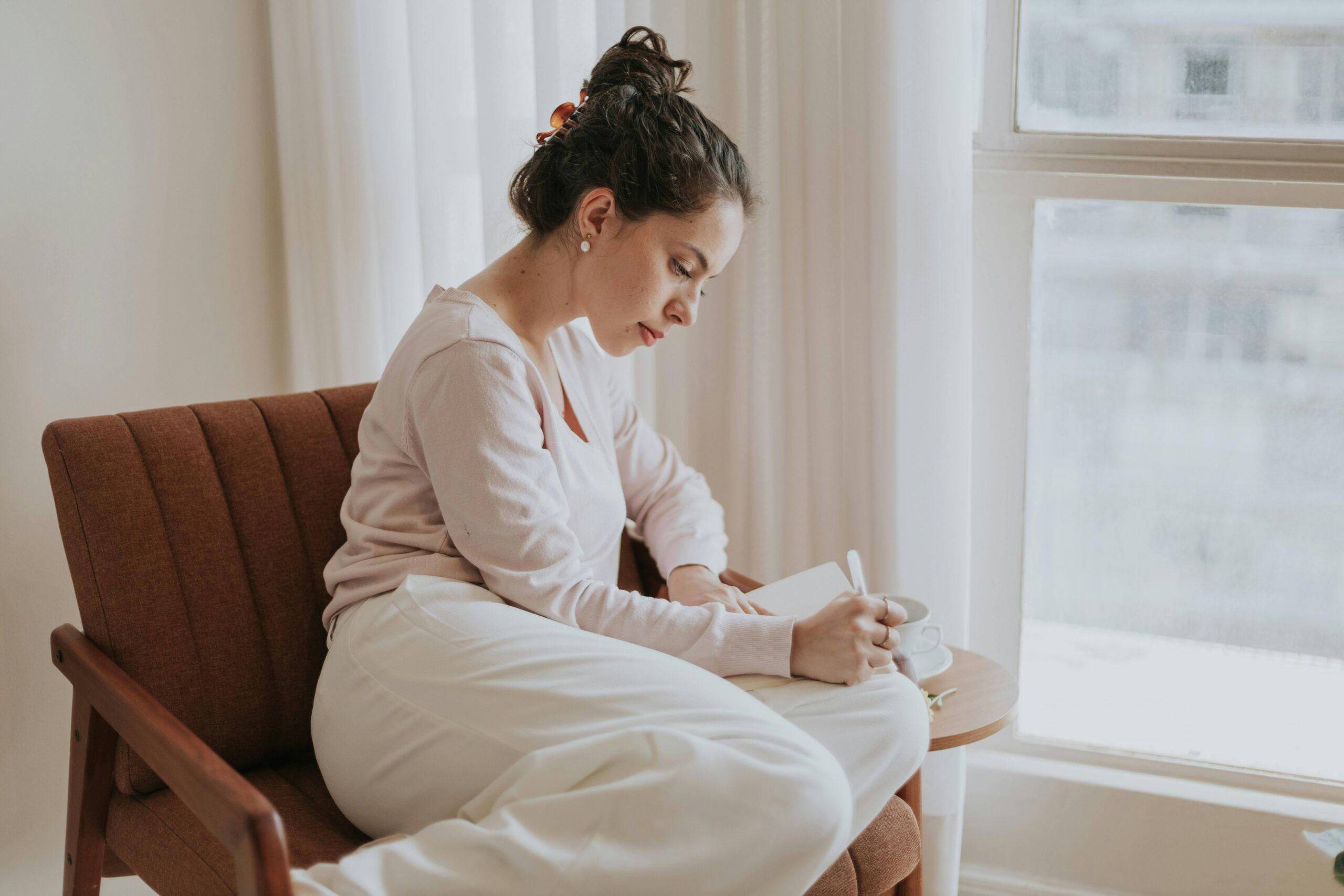 late diagnosed woman journaling and reconnecting with herself